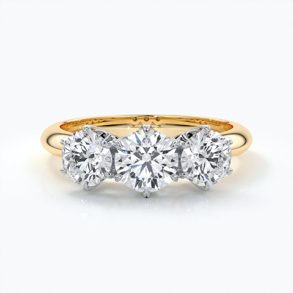 Trilogy diamond ring set in platinum with six claw settings on an eighteen carat gold band