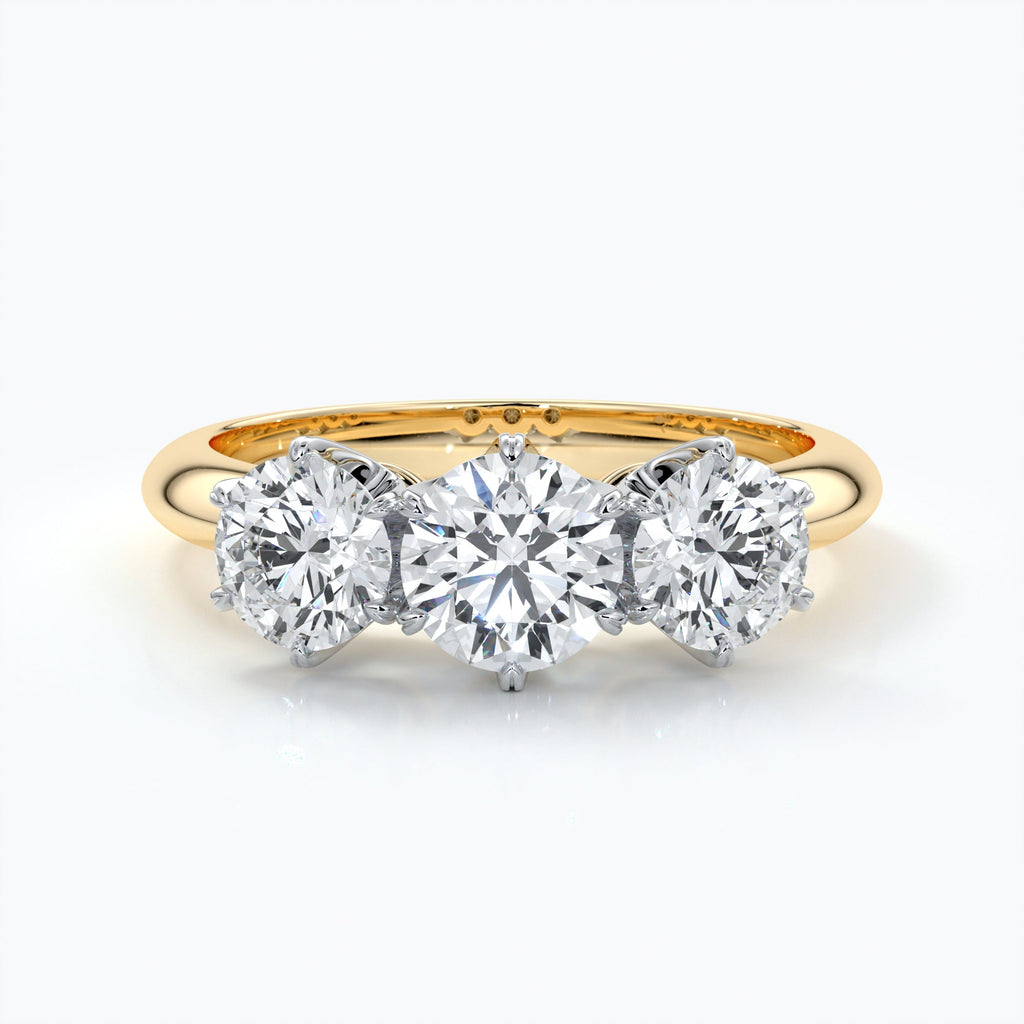 Trilogy diamond ring set in platinum with six claw settings on an eighteen carat gold band