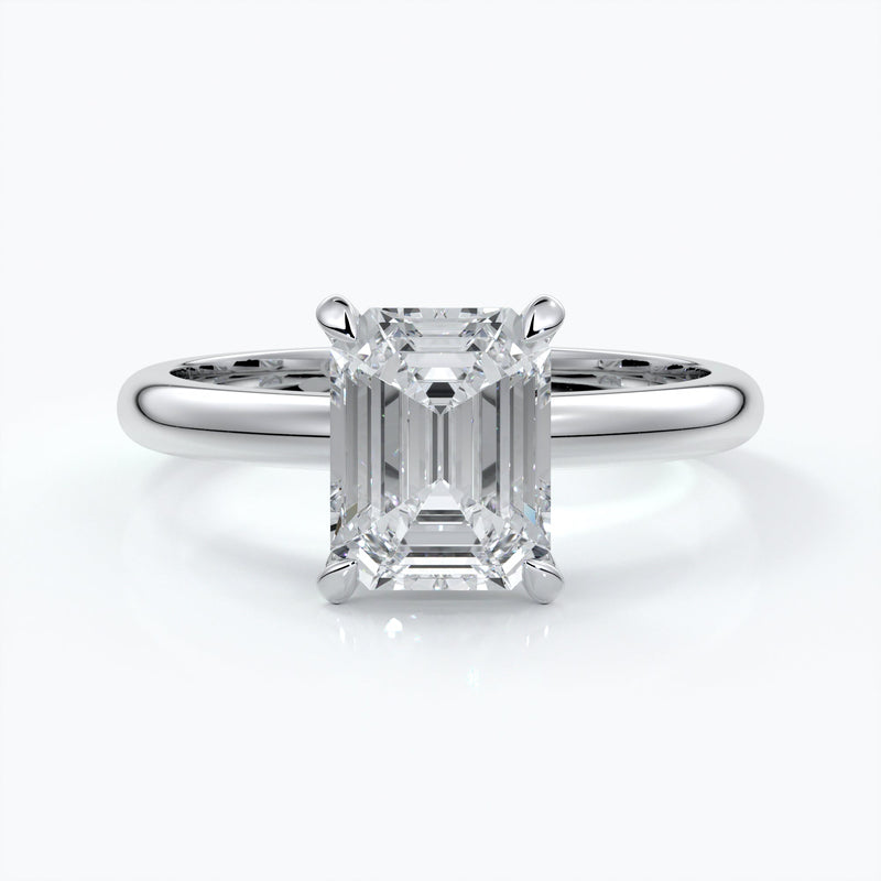 Platinum band with two carat emerald diamond secured with four claws