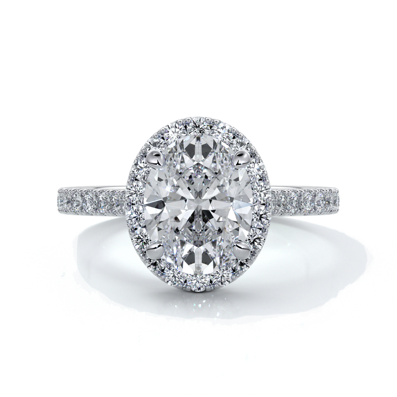 Platinum ring with a two carat oval cut diamond decorated with a scalloped set diamond halo