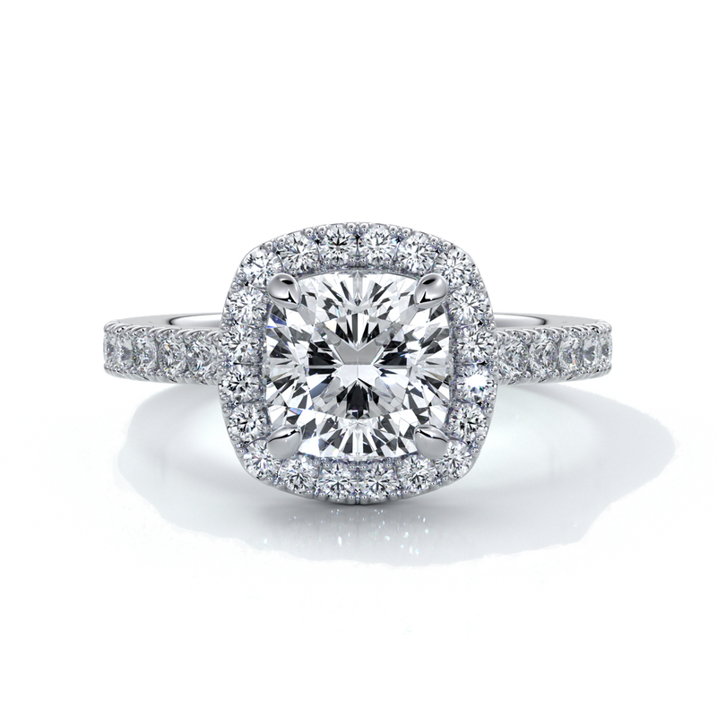 Platinum ring with a one point seven carat cushion cut diamond in a cathedral setting with a scalloped diamond band