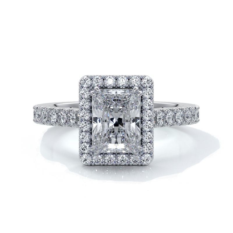 Platinum ring with a one point two carat, a radiant cut emerald diamond in a cathedral setting with a handset scalloped diamond band and halo
