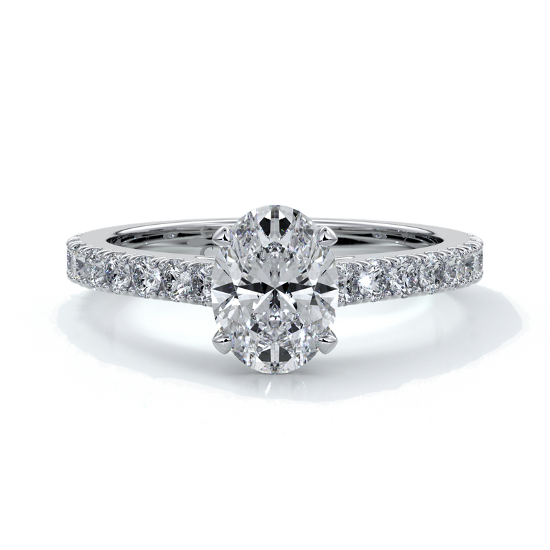 White gold ring with oval diamond secured with four claws and enhanced with cathedral setting with scalloped diamond band