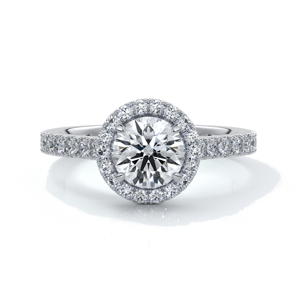 Platinum ring with a one and a half carat round diamond secured in four claws with a halo setting around the center diamond