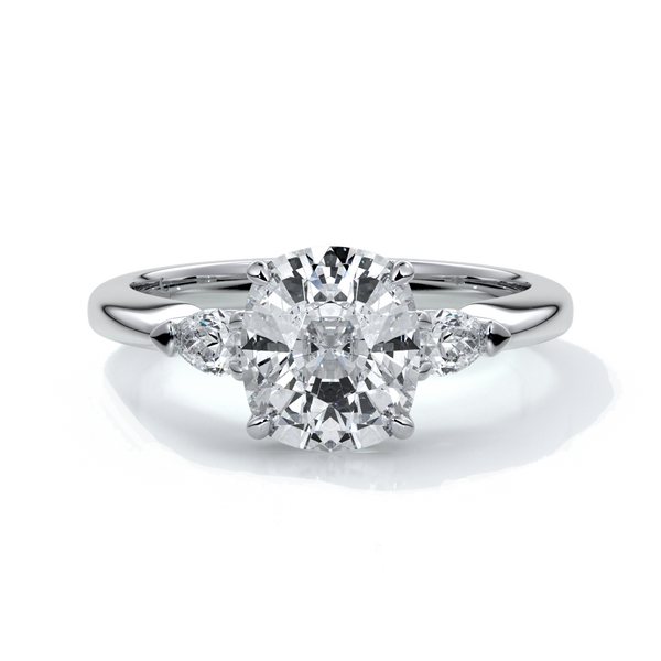Platinum ring with a cushion cut center diamond and pear diamonds enhancing the trilogy