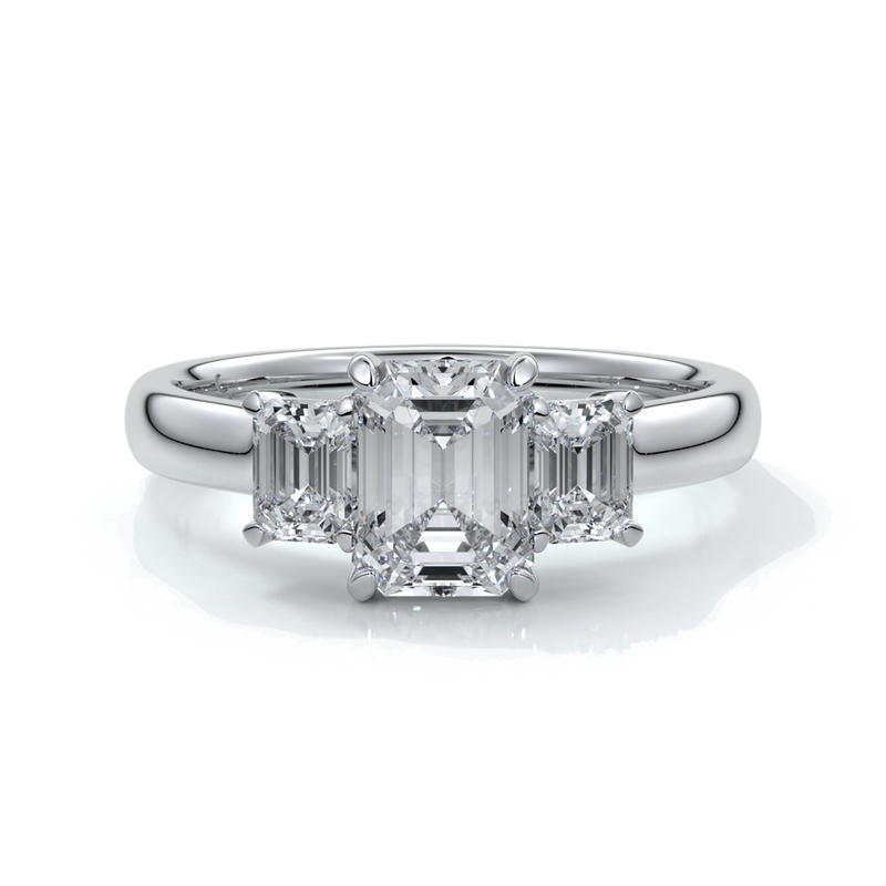 Platinum eighteen carat Stalla emerald cut trilogy diamond ring, with cathedral setting