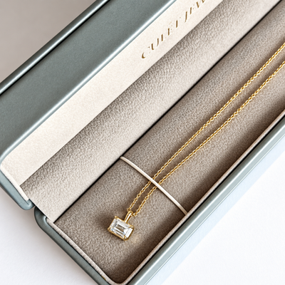 Cascade emerald cut diamond pendant in a velvet gift box