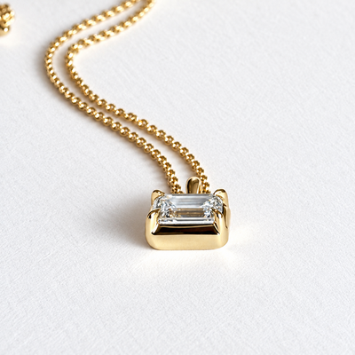Cascade emerald cut pendant on polished 9K yellow gold cable chain