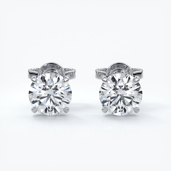 Four claw diamond earrings set in platinum