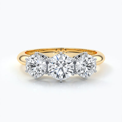 Trilogy diamond ring set in platinum with six claw settings on an eighteen carat gold band