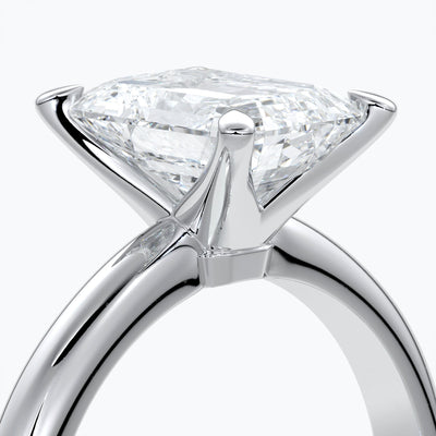 Platinum band with two carat emerald diamond secured with four claws