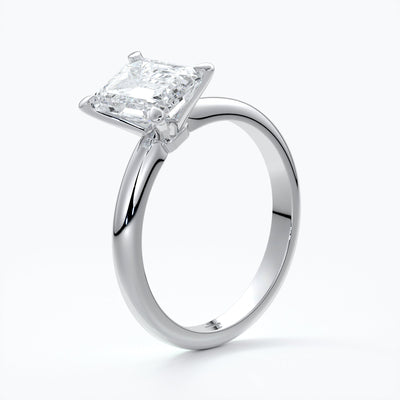 Platinum band with two carat emerald diamond secured with four claws