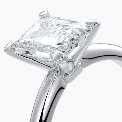 Platinum band with two carat emerald diamond secured with four claws