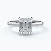 Platinum band with two carat emerald diamond secured with four claws