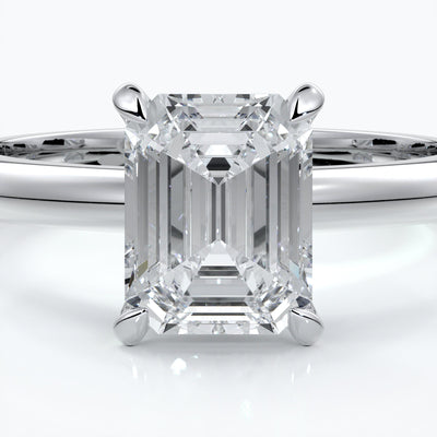 Platinum band with two carat emerald diamond secured with four claws