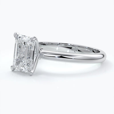 Platinum band with two carat emerald diamond secured with four claws