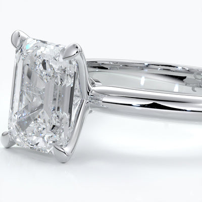 Platinum band with two carat emerald diamond secured with four claws