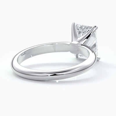 Platinum band with two carat emerald diamond secured with four claws