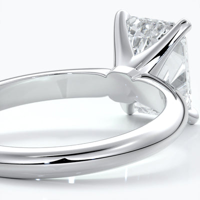 Platinum band with two carat emerald diamond secured with four claws