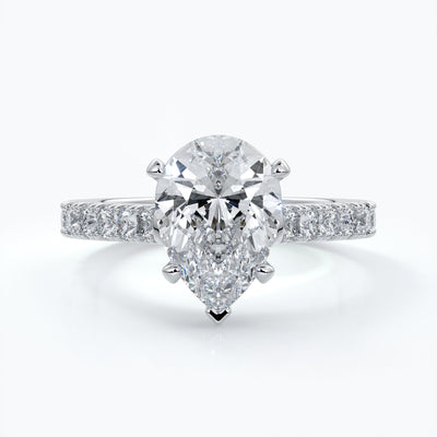 Platinum ring with pear-shaped diamond secured with four claws with shoulder diamond