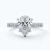 Platinum ring with pear-shaped diamond secured with four claws with shoulder diamond
