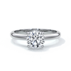 Platinum band with circle diamond secured by four claws