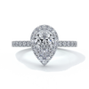 Platinum ring with a one carat pear cut halo diamond set in a double claw with cathedral setting and shoulder diamonds