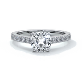 Platinum diamond band ring with cushion cut diamond secured with four claws