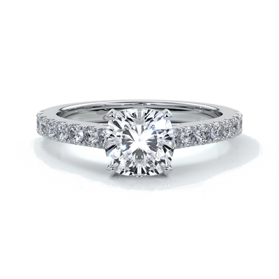 Platinum diamond band ring with cushion cut diamond secured with four claws
