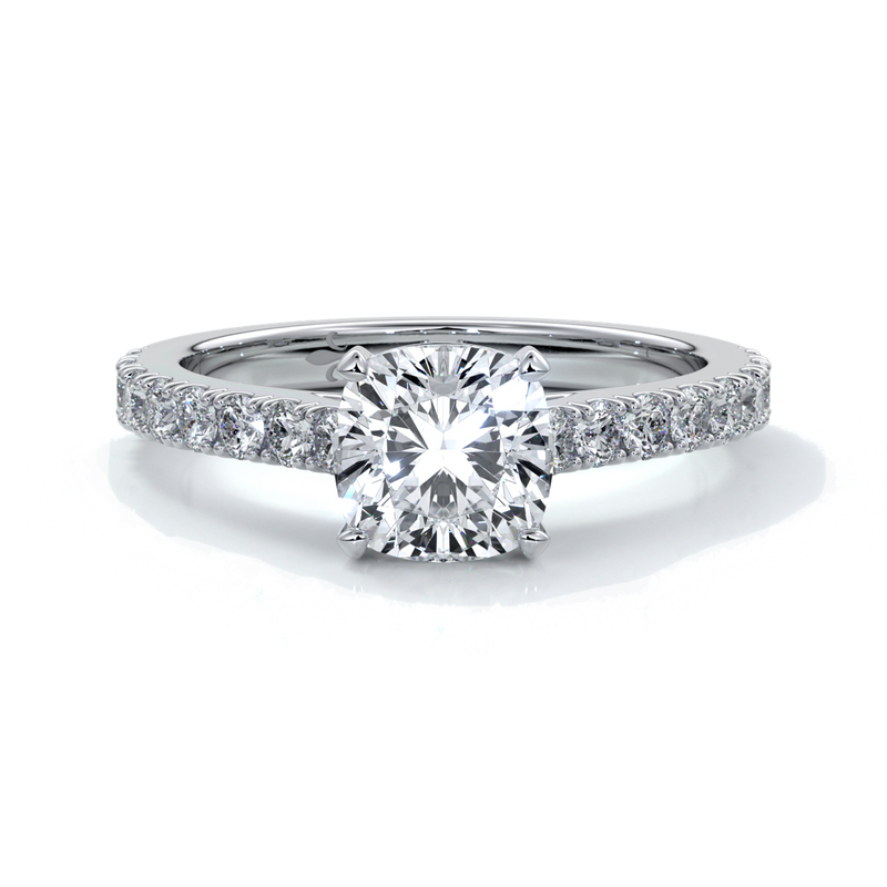 Platinum diamond band ring with cushion cut diamond secured with four claws