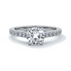 Platinum diamond band ring with cushion cut diamond secured with four claws