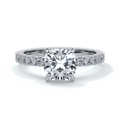 Platinum ring with cushion cut one and a half carat diamond secured with four claws and diamonds on the shoulder