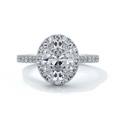 Platinum ring with a two carat oval cut diamond decorated with a scalloped set diamond halo