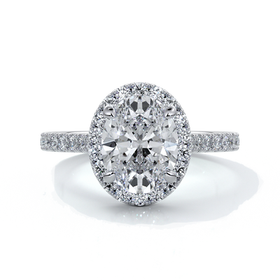 Platinum ring with a two carat oval cut diamond decorated with a scalloped set diamond halo