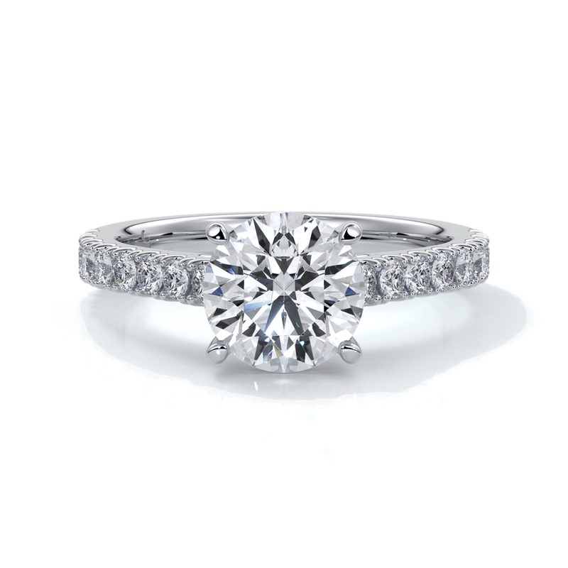 Platinum ring with round diamond secured with four claws in a cathedral setting with shoulder diamonds