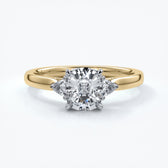 Gold diamond ring with four claws attaching diamond with two smaller diamonds on eachs side