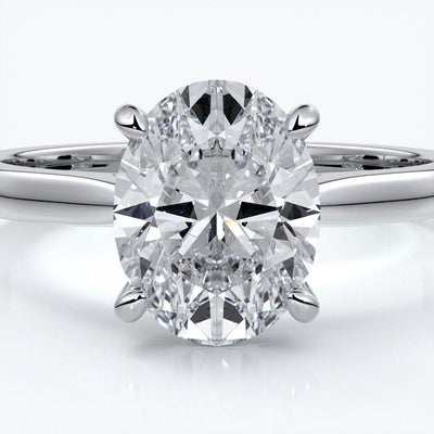 Platinum band with oval diamond secured with four claws