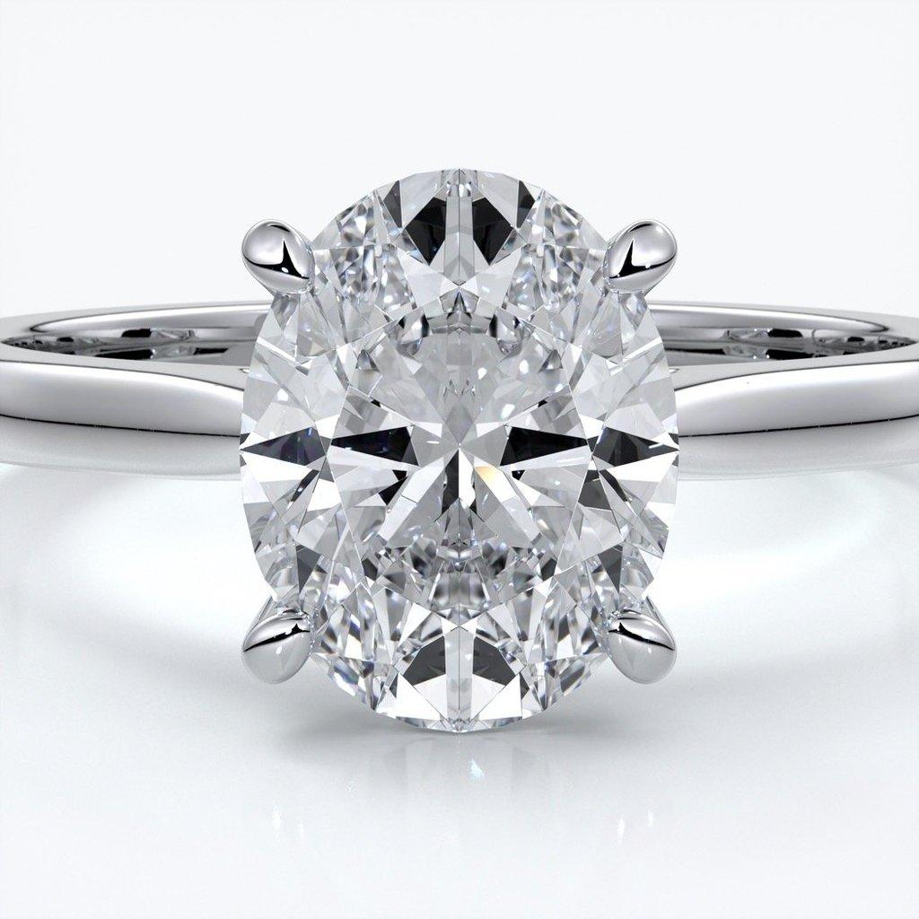 Platinum band with oval diamond secured with four claws