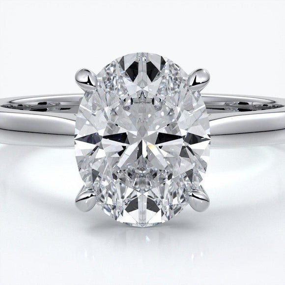 Platinum band with oval diamond secured with four claws