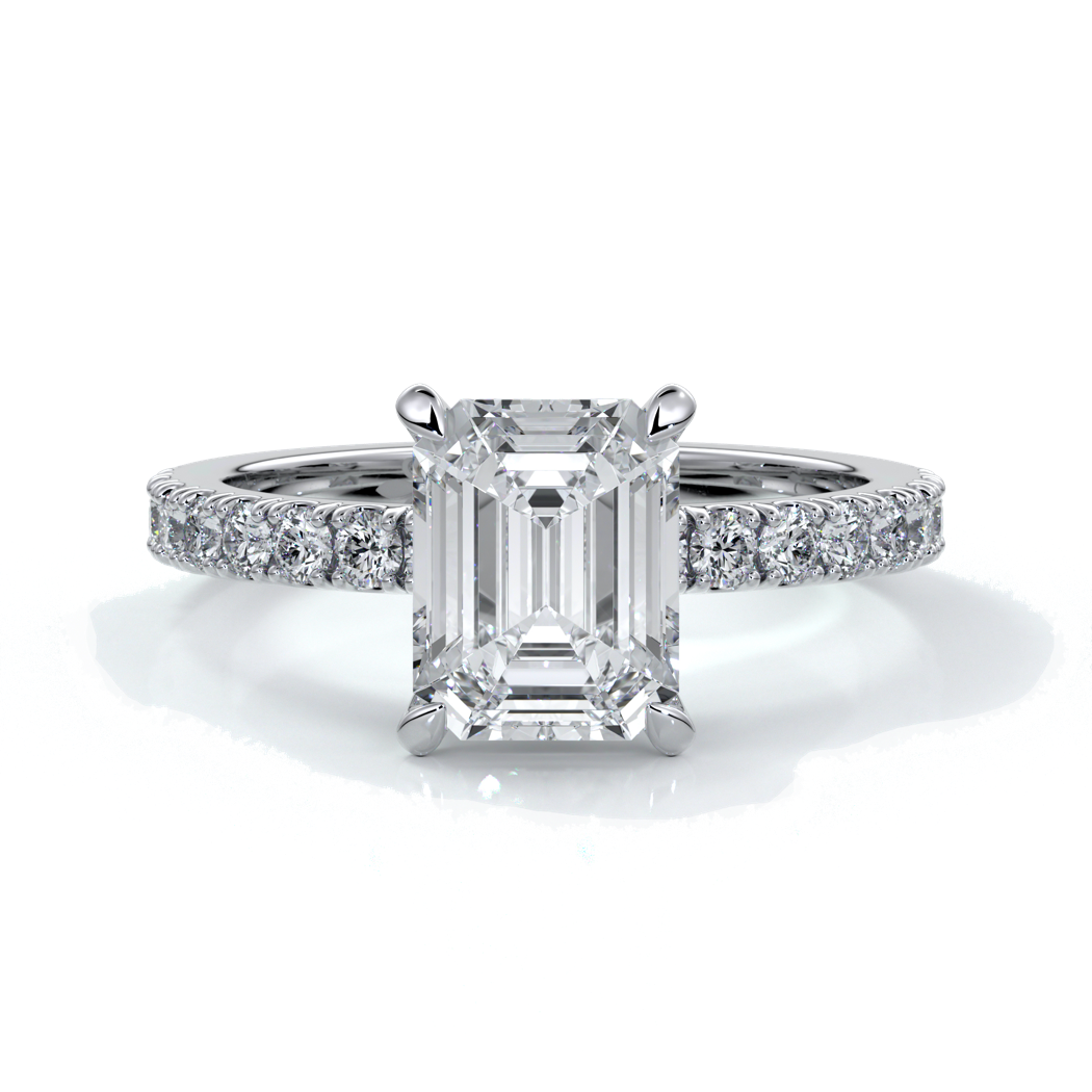 Platinum ring with a two carat emerald cut diamond secured with four claws enhanced with shoulder diamonds