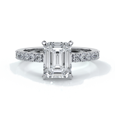 Platinum ring with a two carat emerald cut diamond secured with four claws enhanced with shoulder diamonds