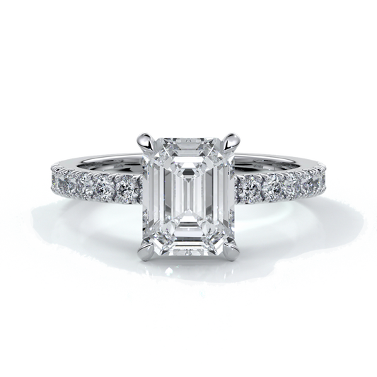 Platinum ring with a two carat emerald cut diamond secured with four claws enhanced with shoulder diamonds