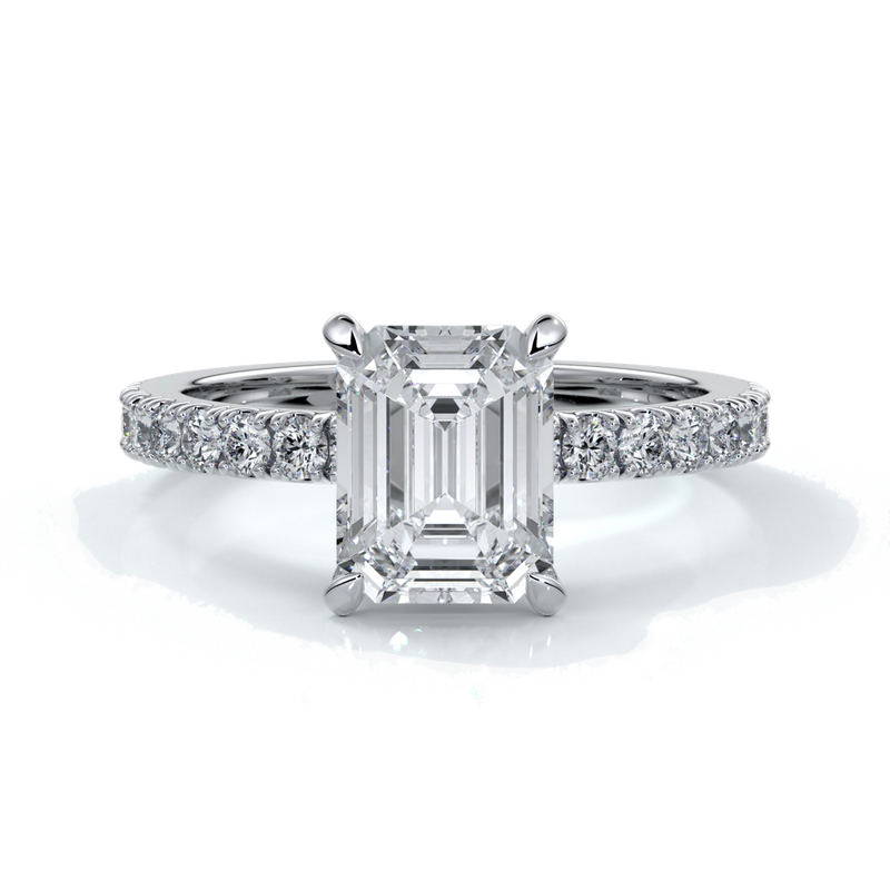 Platinum ring with a two carat emerald cut diamond secured with four claws enhanced with shoulder diamonds