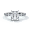 Platinum ring with a two carat emerald cut diamond secured with four claws enhanced with shoulder diamonds