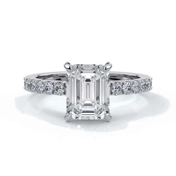 Platinum ring with a two carat emerald cut diamond secured with four claws enhanced with shoulder diamonds
