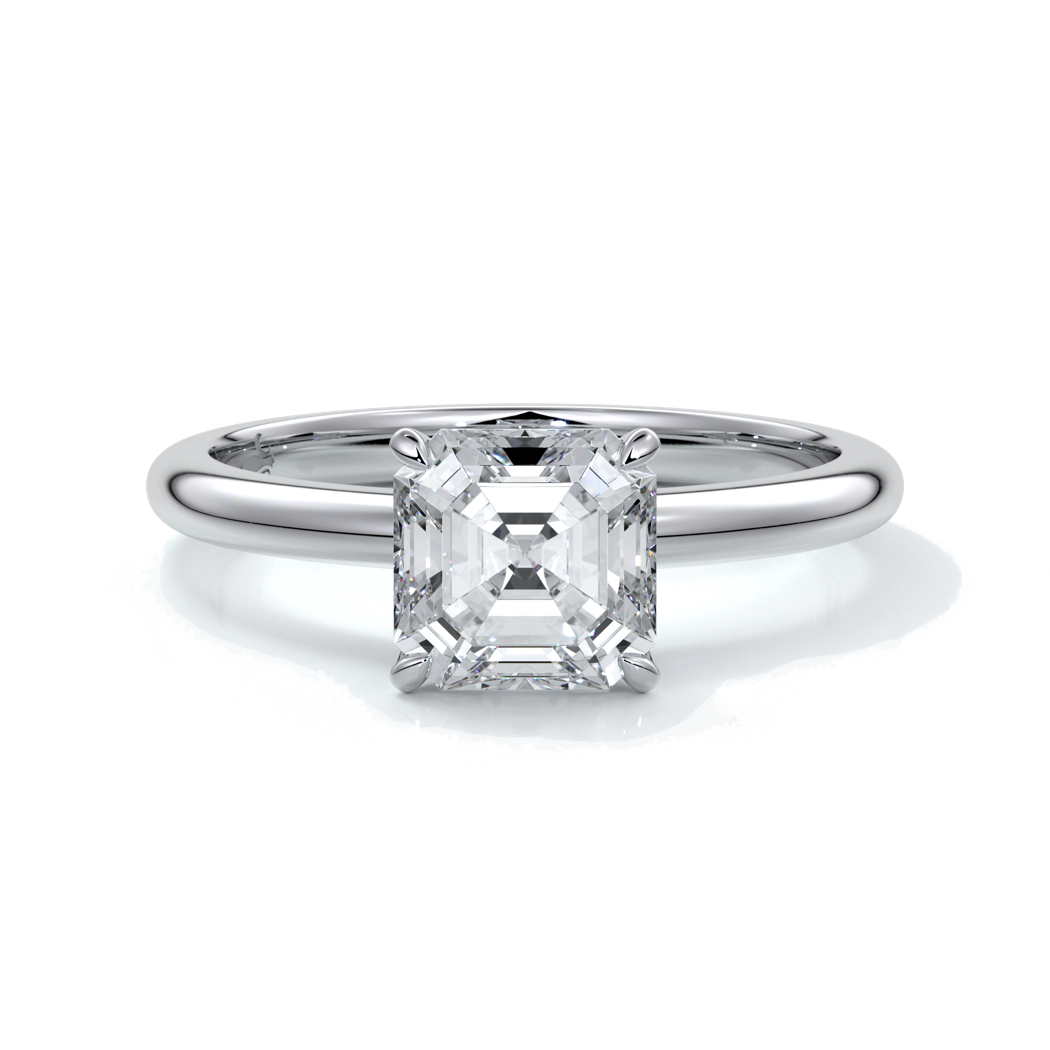 Platinum ring with emerald diamond secured with four claws