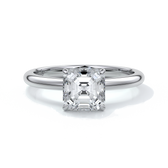 Platinum ring with emerald diamond secured with four claws