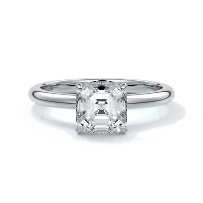 Platinum ring with emerald diamond secured with four claws
