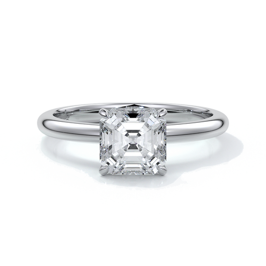 Platinum ring with emerald diamond secured with four claws