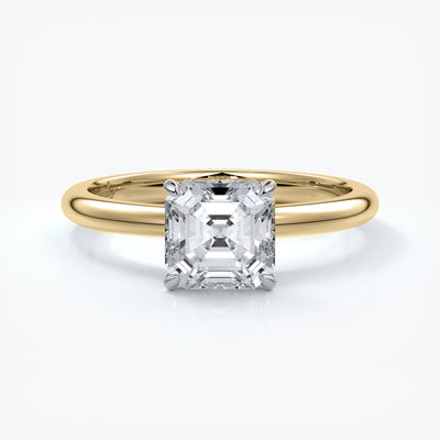 Gold ring with emerald cut diamond held by four claws